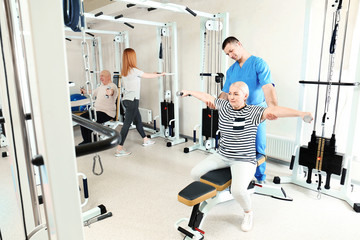 Wall Mural - Patient exercising under physiotherapist supervision in rehabilitation center