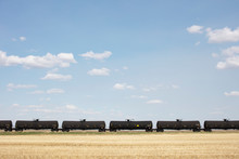 View Of Oil Train Cars Passing Through Farmland