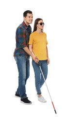 Wall Mural - Man assisting blind woman with long cane on white background