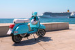 Blue retro scooter near sea. Travel concept.