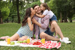 © New Africa - Happy family having picnic in park on summer day
