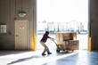 © Mint Images - Worker using pallet jack in warehouse