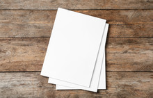 Stack Of Blank Paper Sheets For Brochure On Wooden Background, Top View. Mock Up