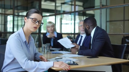 Wall Mural - Stressed business woman suffering shouting emotional colleagues arguing office