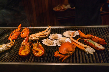 Wall Mural - Grilling lobsters and seafood in barbecue restaurant