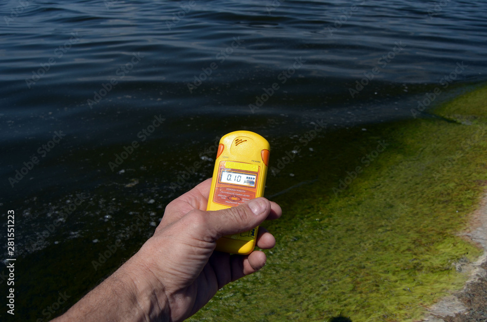 Geiger counter near storage pool near of hydroelectric station. After ...