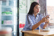 © SVRSLYIMAGES - woman sit and use smart phones in the cake shop