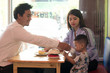 © SVRSLYIMAGES - asian family inside cake store and cafe