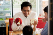 © SVRSLYIMAGES - asian father and his son at cake store and cafe