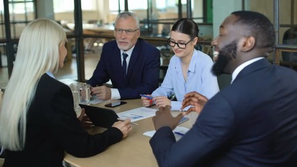 Wall Mural - Office workers negotiating in meeting room, business offer, partnership deal