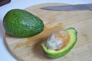 Natural organic ripe avocado. Half avocado on white background. Isolated. Top view.