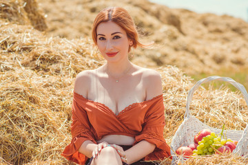 Country vintage mix style,  woman with basket of fruits at field . Portrait of nice lady at hayloft 