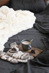 Poster - Coffee with chocolate, woolen socks and blanket in unmade bed