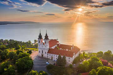 Wall Mural - Tihany, Hungary - Aerial skyline view of the famous Benedictine Monastery of Tihany (Tihany Abbey) with beautiful colourful sky and clouds at sunrise over Lake Balaton