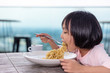 Leinwandbild Motiv Asian Little Chinese Girl eating spaghetti
