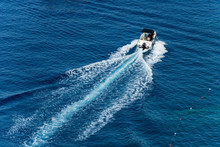 White Motorboat In Motion With Wake In The Blue Mediterranean Sea Photographed From Above. Cinque Terre, Liguria, Italia, Europe