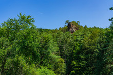 Rocks Towering Through Trees In A Forest Landscape In Dahn Rockland