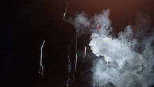 The Woman And Man Walking Through The Smoke. Slow Motion