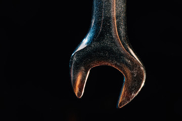 wrench on a black background, metal texture