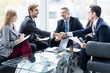 © opolja - Business people shaking hands, finishing up a meeting. Handshake. Business concept.