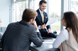 © opolja - Businesspeople discussing together in conference room during meeting at office.