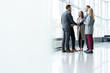 © opolja - Business people shaking hands, finishing up a meeting. Handshake. Business concept.