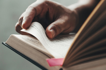 close up man hands.young man opening and reading a book,