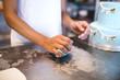 © romul014 - A woman decorates and makes cakes in a pastry shop