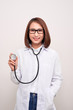© makistock - young doctor woman holding stethoscope isolated on white background