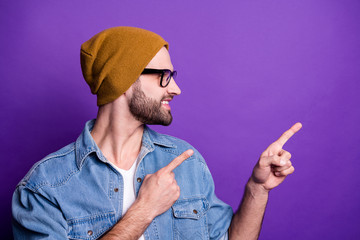 Poster - Close-up portrait of his he nice attractive confident cheerful cheery glad bearded guy pointing two forefingers aside ad advert solution isolated over bright vivid shine violet lilac background