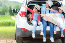 Group Asian Family Children Checking Map And Pointing On The Car Adventure And Tourism For Destination And Leisure Trips Travel For Education And Relax In Nature Park .  Travel Vacations