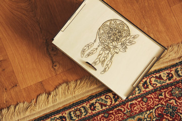 Wall Mural - Wooden box on a background of wooden floor and carpet. Handmade box