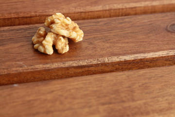 Peeled walnuts on wooden background