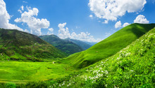 Beautiful Green Mountain Valley. Scenic Grassy Mountains. Summer Day In Georgia. Amazing Bright Mountain Landscape. Green Hills And Clouds On Blue Sky