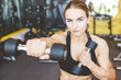 © xartproduction - Working out with dumbbell weights at the gym.Fitness Women exercising are lifting dumbbells. Fitness muscular body.Workout at gym.