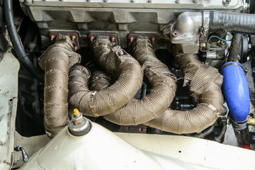 A detail of the sports car engine. It is a historic rallye car from the past. 