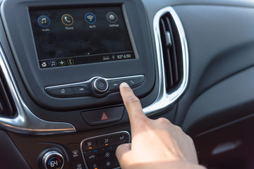 Male hand press the Next button on modern car dashboard