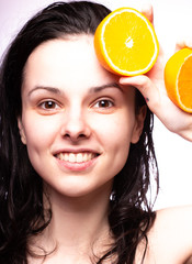 beautiful girl with oranges smiling