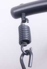 Closed-up steel hook and spring on white background 