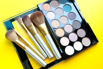 Brushes and accessories for women.fashion professional equipment attractive  On a yellow background.Beauty concept