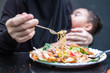 © phoderstock - Mother eating spicy while baby sleep and breastfeeding in the restuarant. Baby in mother's hugging and breastfeeding while mother is eating.