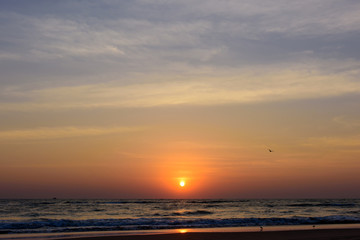 Beautiful sky colorful sunset on the ocean, natural landscapes. Deserted beach, the sun sets in the clouds above the sea.