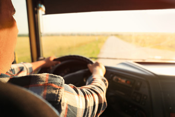 Wall Mural - Man driving modern truck on sunny day, closeup