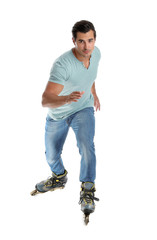 Poster - Handsome young man with inline roller skates on white background