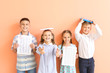 © Pixel-Shot - Happy children with answer sheets for school test on color background