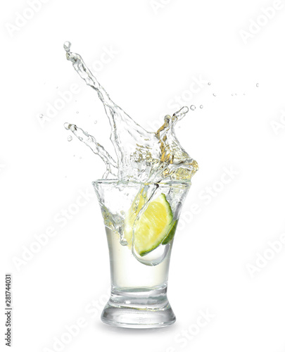 Cuadros en Lienzo Dropping of lime into glass with tasty tequila on light background