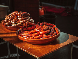 grilled sausages on clay plate in a fair