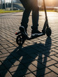 © bortnikau - Close up view of legs of man on electric scooter outdoor.