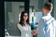 © bnenin - Two business people greeting in the office.