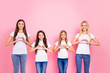 © deagreez - Four ladies making heart figure symbol with hands wear casual outfit isolated pink background